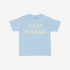 Light-blue Fight Fascism Women's Baby Tee featuring the slogan “FIGHT FASCISM” in distressed, off-white letters with a small brand logo beneath. Ideal for anti-fascists, equality supporters, or protest-goers.