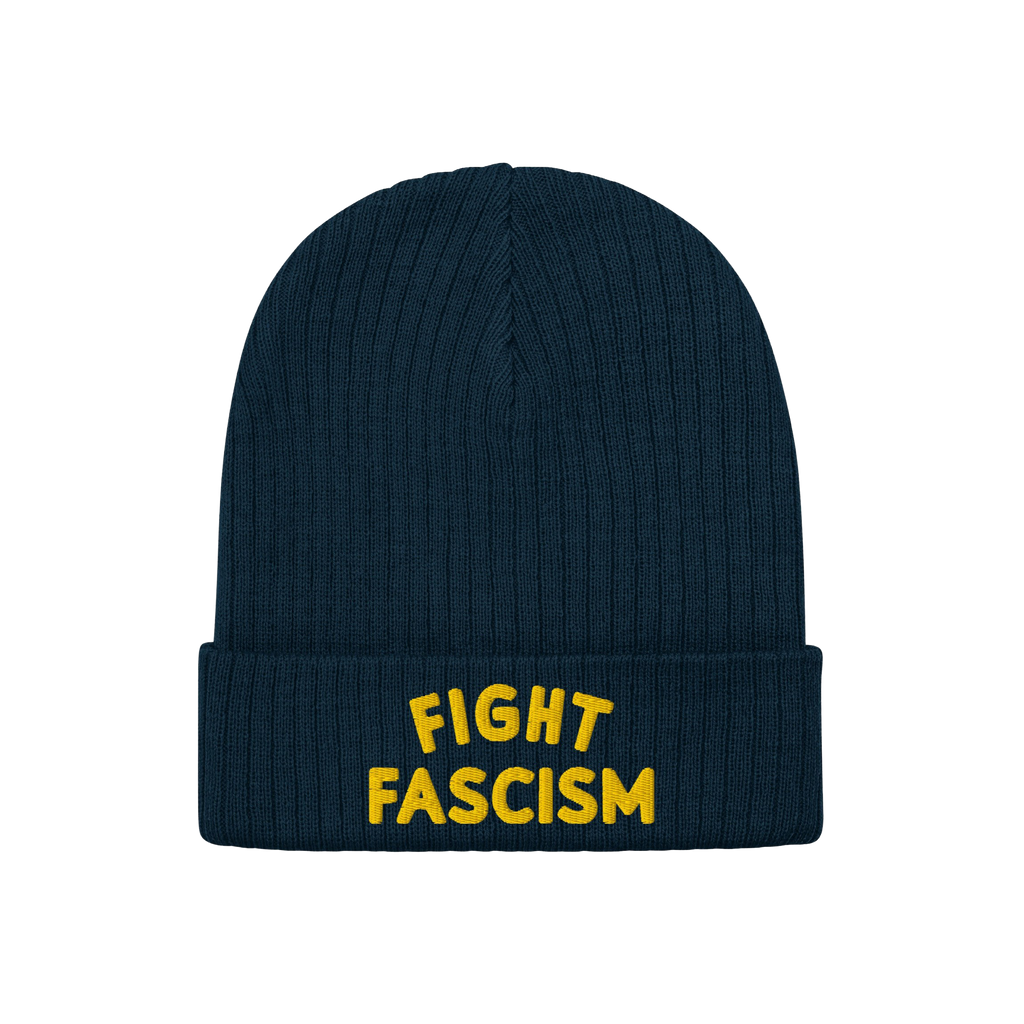 The Fight Fascism Hat is a dark-blue ribbed knit beanie with a folded cuff, featuring bold yellow FIGHT FASCISM embroidery, i