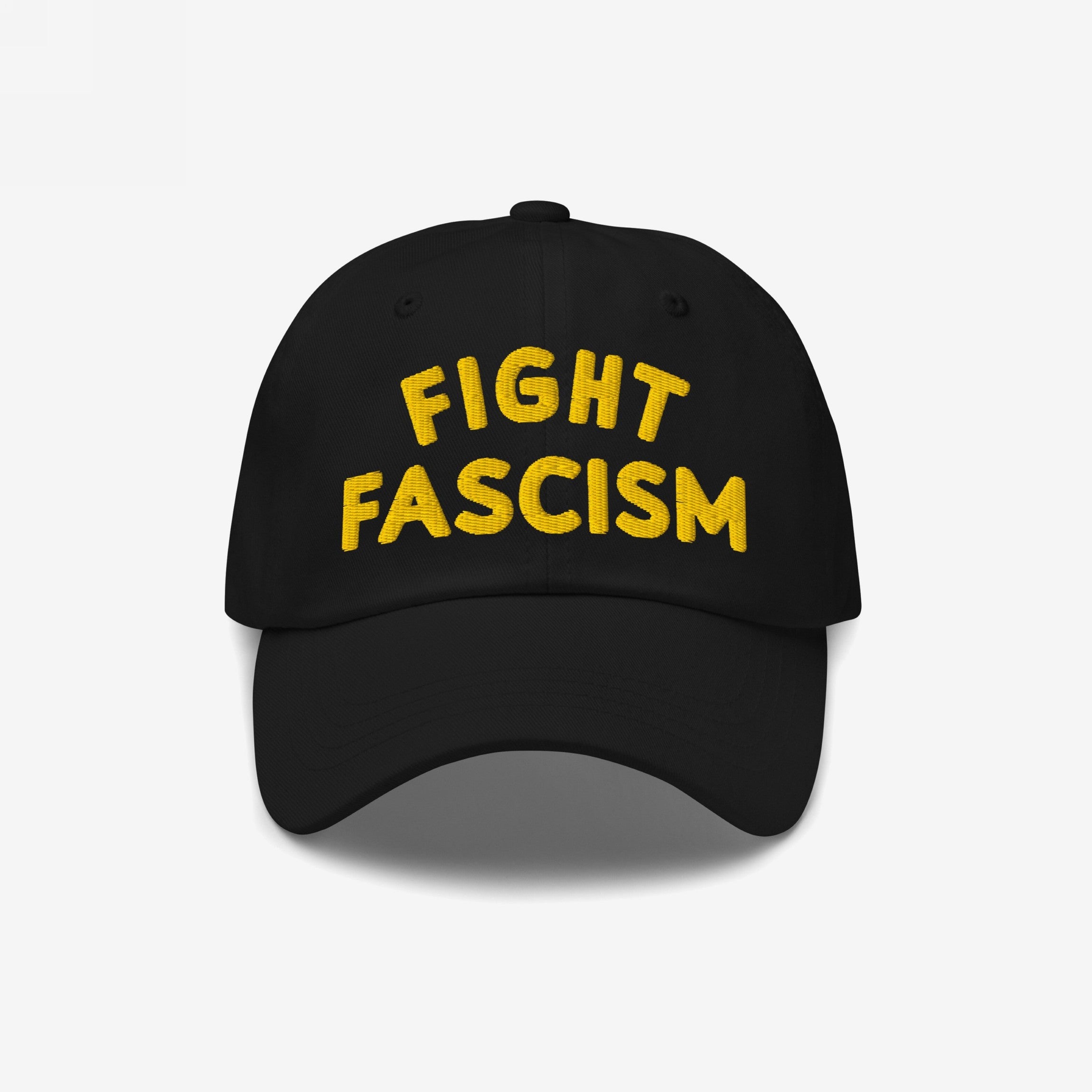 Fight Fascism Hat featuring bold yellow embroidery on a black baseball cap, symbolizing protest and visibility against hate, ideal for marches or daily wear.