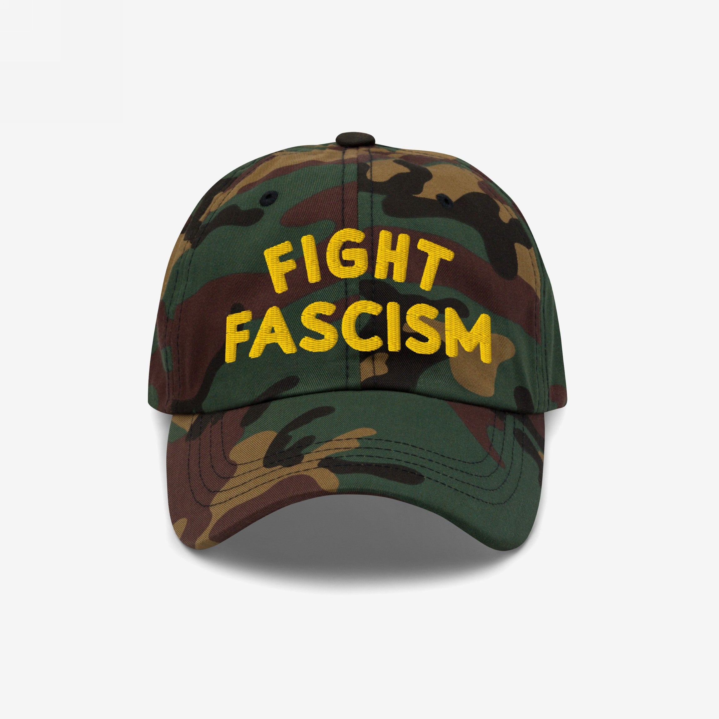 Camo-pattern Fight Fascism Hat with bold yellow FIGHT FASCISM slogan, designed for anti-fascist visibility. Ideal for marches or daily wear, embodying a message of resistance and equality.