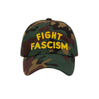 Camo-pattern Fight Fascism Hat with bold yellow FIGHT FASCISM slogan, designed for anti-fascist visibility. Ideal for marches