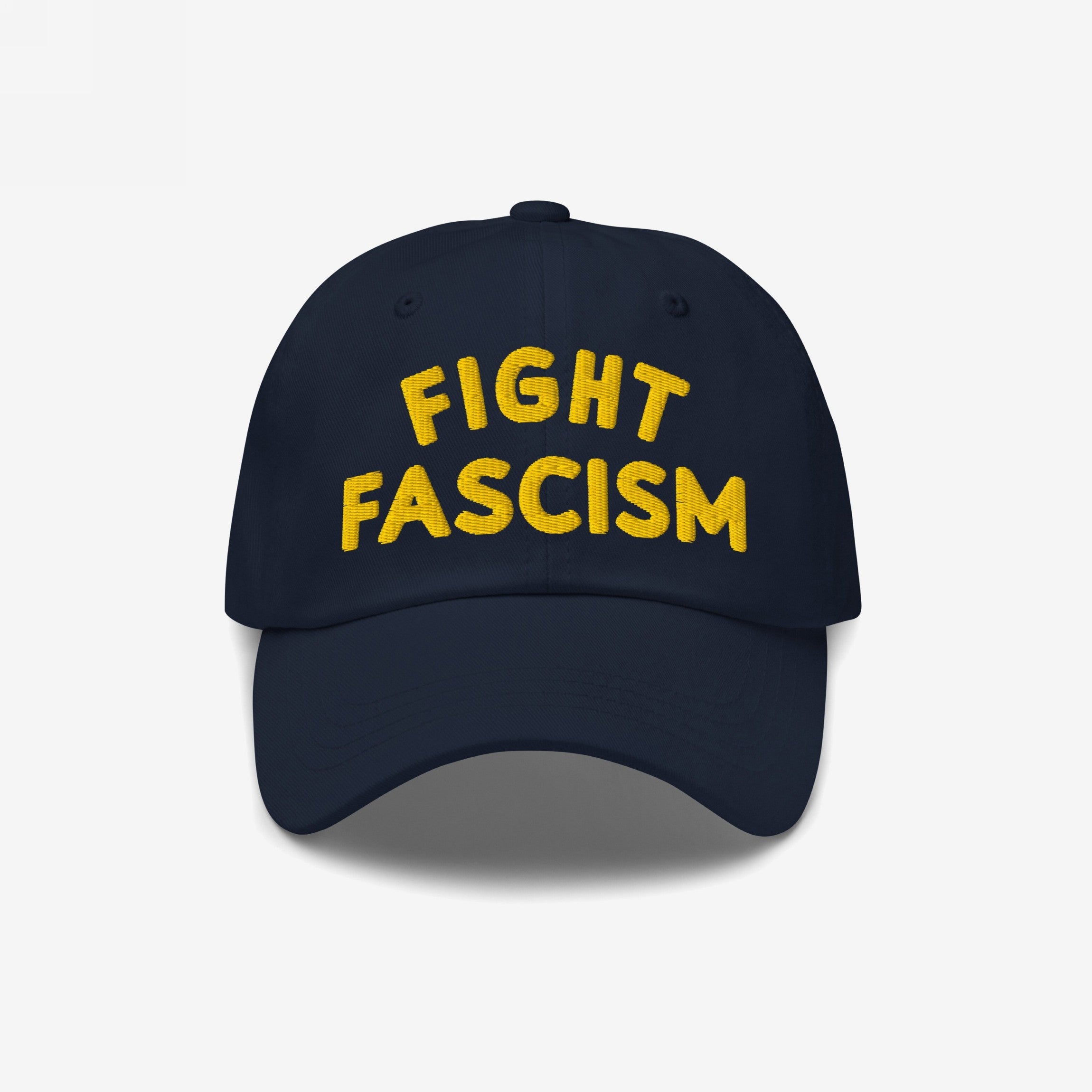 Fight Fascism Hat with bold yellow embroidery on the front, proclaiming FIGHT FASCISM in block letters, ideal for making a visible anti-fascist statement during any public outing.
