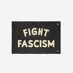 Fight Fascism Flag with bold cream letters on a black banner, featuring white stitching and metal grommets for easy display, representing a clear anti-fascist statement and support for equality.