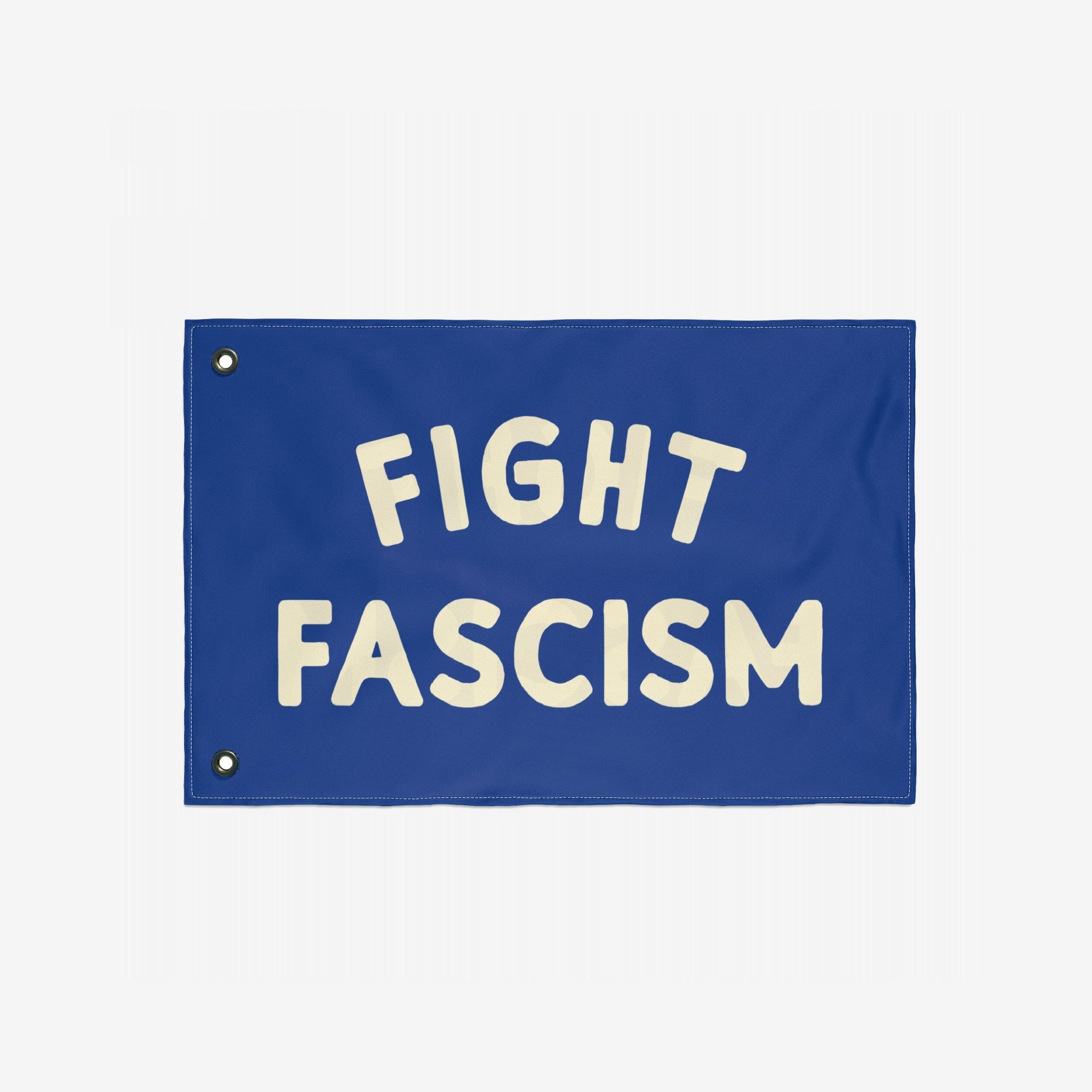 Fight Fascism Flag: A bold blue banner featuring FIGHT and FASCISM in large cream letters. Designed for activists, it includes metal grommets for easy display, supporting equality and anti-fascist movements.