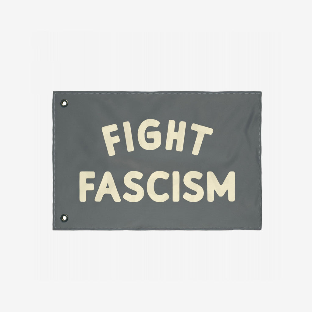 Fight Fascism Flag featuring bold, off-white FIGHT FASCISM text on a gray background with metal grommets for hanging; designed for protests, equality, and anti-fascist activism.