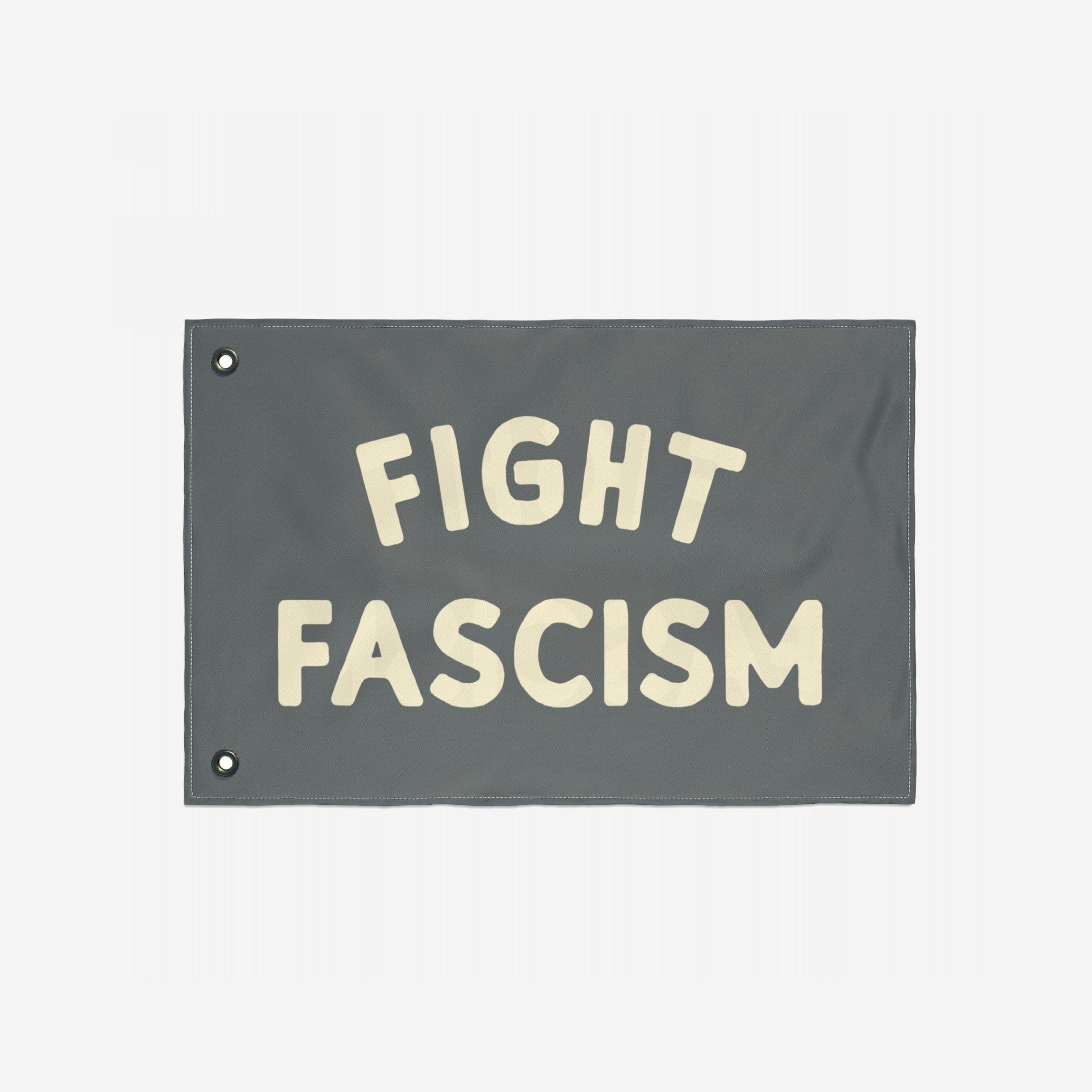 Fight Fascism Flag featuring bold, off-white FIGHT FASCISM text on a gray background with metal grommets for hanging; designed for protests, equality, and anti-fascist activism.