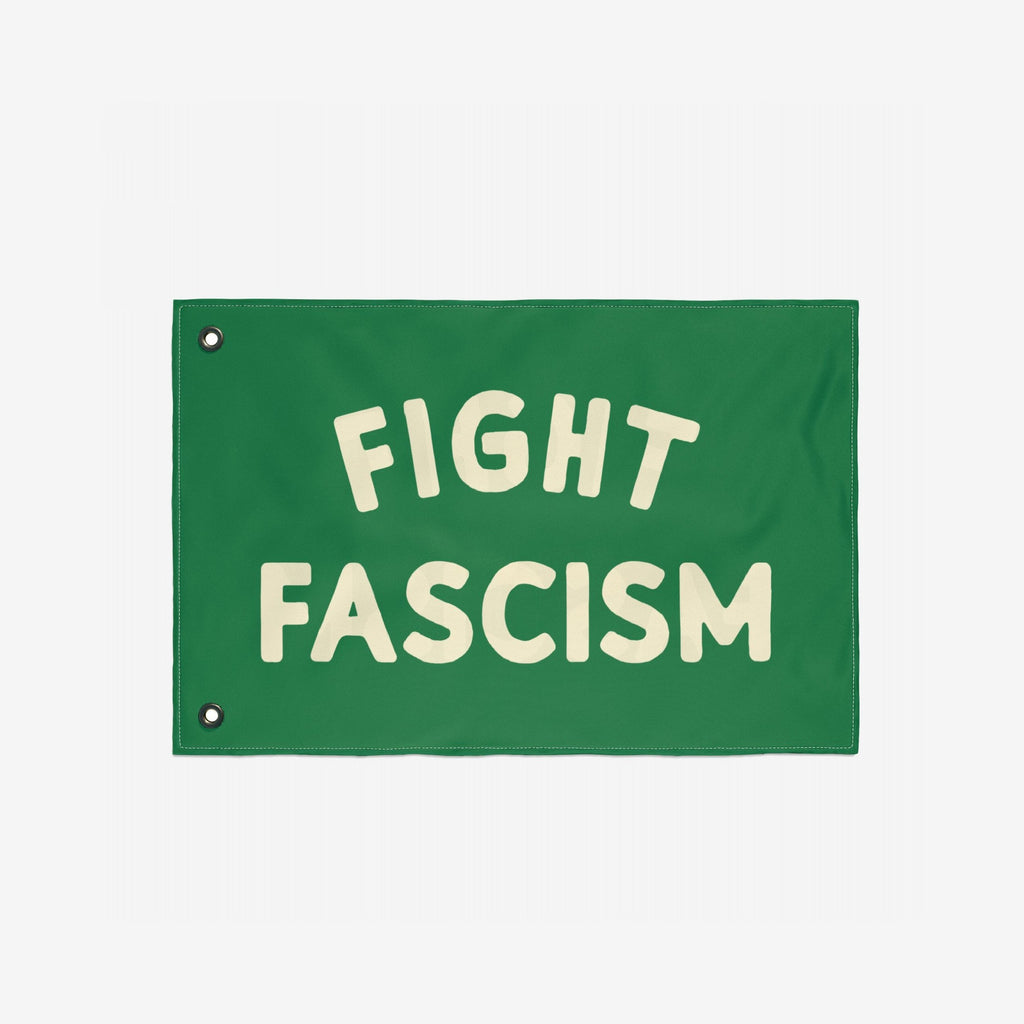 Fight Fascism Flag with bold cream letters centered on a green background, featuring metal grommets along the left edge for easy hanging. Designed for anti-fascist activism and available in multiple sizes.