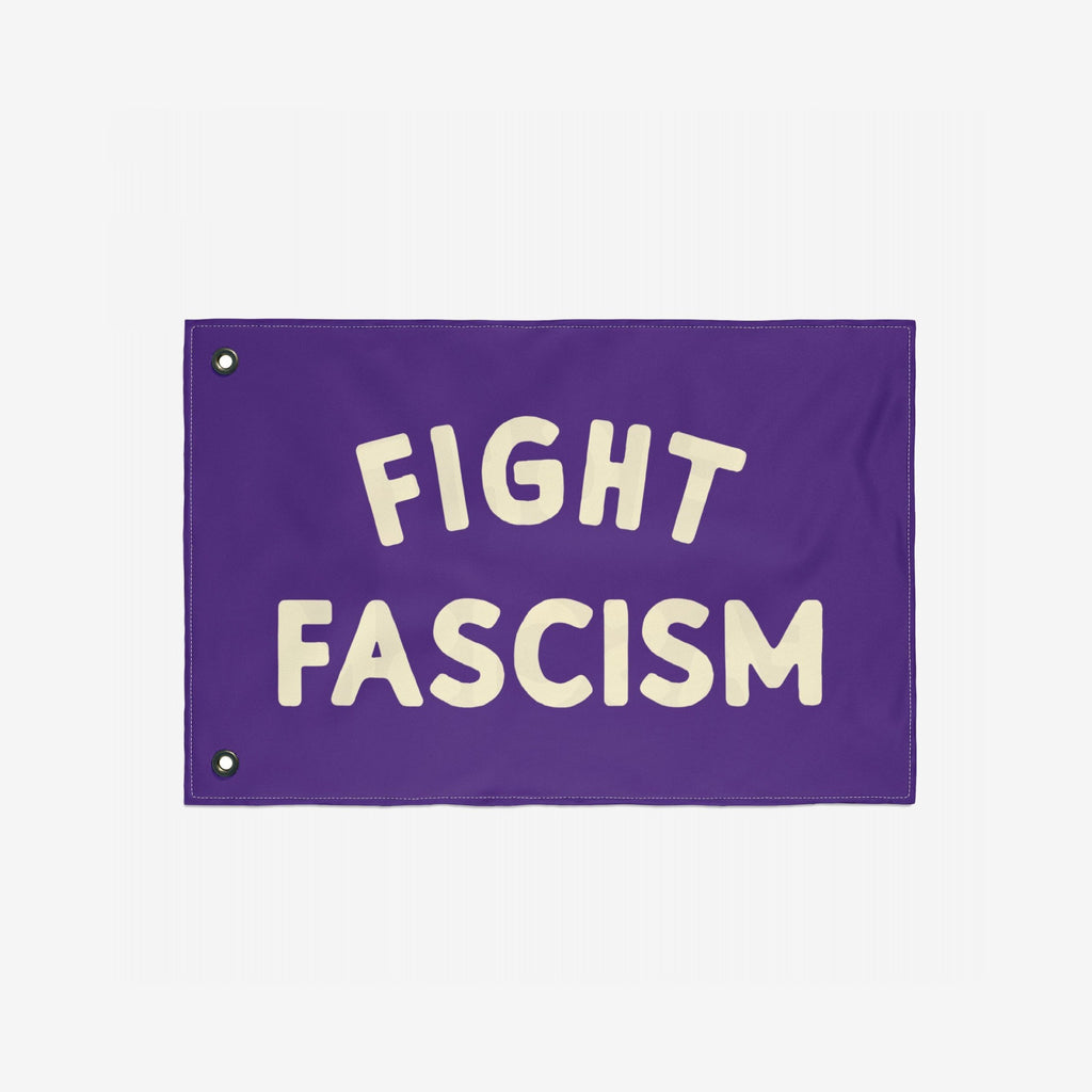 The Fight Fascism Flag features bold cream lettering on a purple background, designed for protest and equality advocacy, complete with metal grommets for easy display.