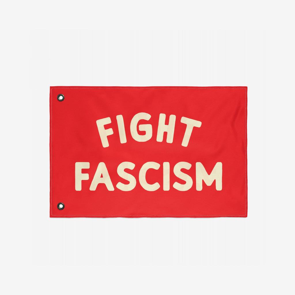 Fight Fascism Flag with bold cream letters centered on a red background, featuring metal grommets for easy hanging. Designed for anti-fascist protests, advocating equality and solidarity.