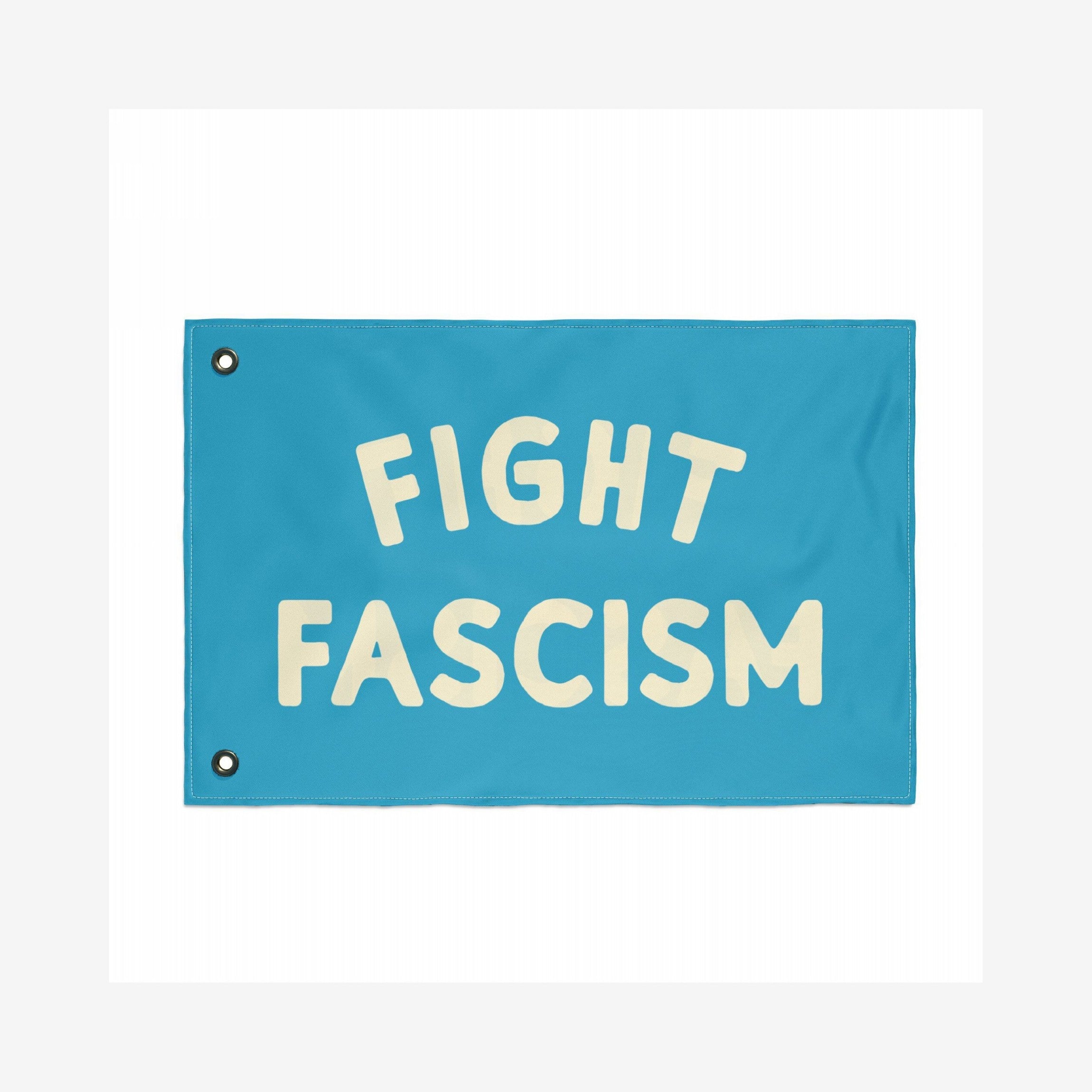 The Fight Fascism Flag features bold cream lettering on a teal background, with metal grommets for easy hanging, embodying a strong anti-fascist message for activism and community events.