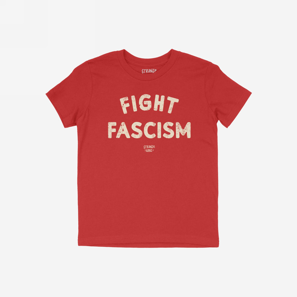 Red Fight Fascism T-shirt with bold, distressed cream lettering and smaller brand tagline underneath, symbolizing anti-fascist activism. Displayed on a white background, ideal for protests and promoting equality.
