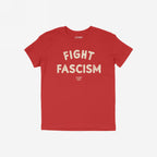 Red Fight Fascism T-shirt with bold, distressed cream lettering and smaller brand tagline underneath, symbolizing anti-fascist activism. Displayed on a white background, ideal for protests and promoting equality.
