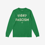 Long-sleeve green Fight Fascism T-shirt with off-white distressed block letters, featuring a small maker's mark beneath the slogan, symbolizing a bold anti-fascist statement.