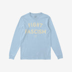 The Fight Fascism T-shirt features FIGHT FASCISM in large cream distressed letters on light-blue fabric, with subtle branding text below, embodying an anti-fascist message.
