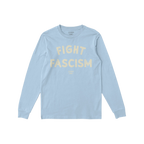 The Fight Fascism T-shirt features FIGHT FASCISM in large cream distressed letters on light-blue fabric, with subtle branding