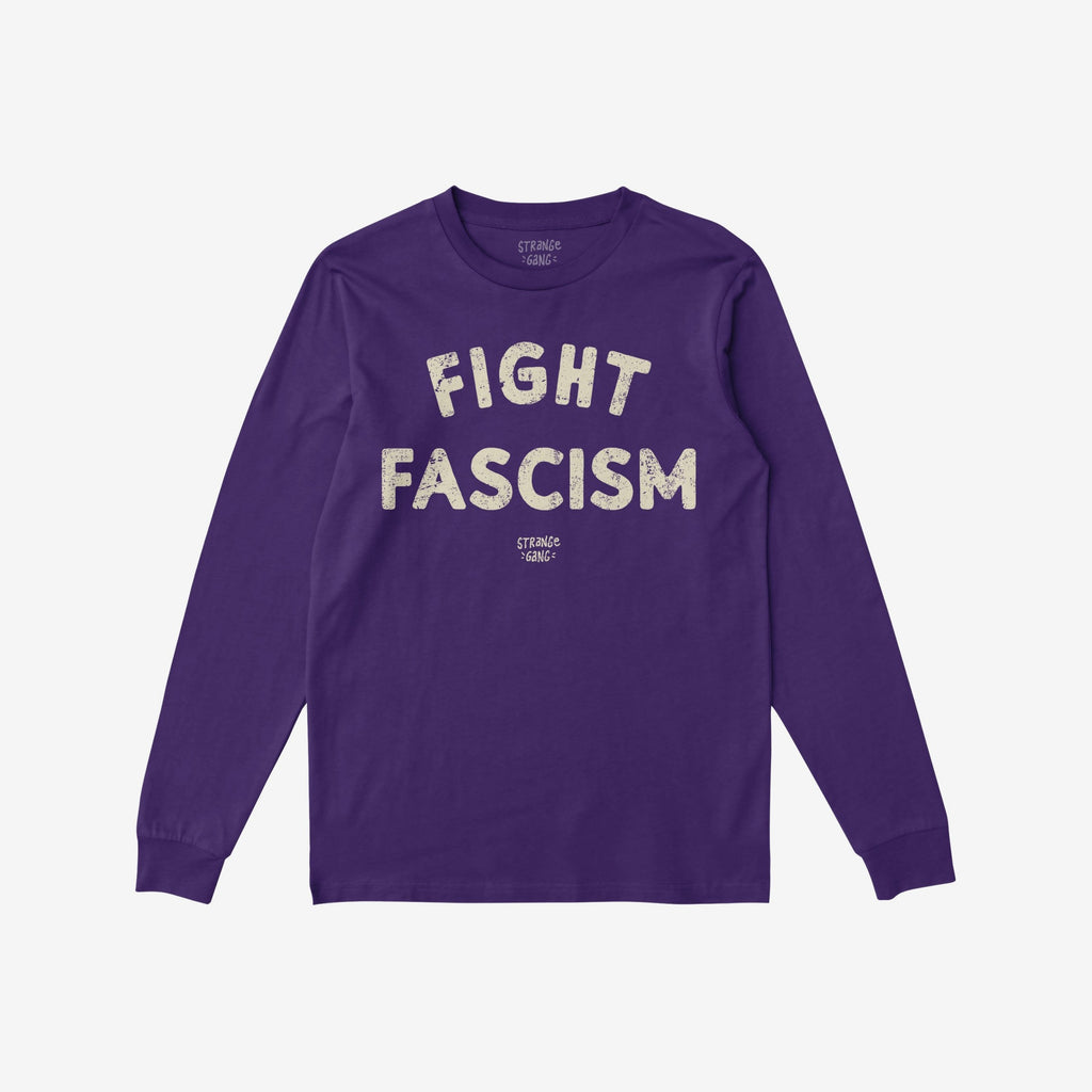 Deep purple long-sleeve crewneck T-shirt with “FIGHT FASCISM” in distressed off-white letters across the chest, ribbed cuffs, and straight hem, embodying a bold anti-fascist message.