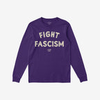 Deep purple long-sleeve crewneck T-shirt with “FIGHT FASCISM” in distressed off-white letters across the chest, ribbed cuffs, and straight hem, embodying a bold anti-fascist message.