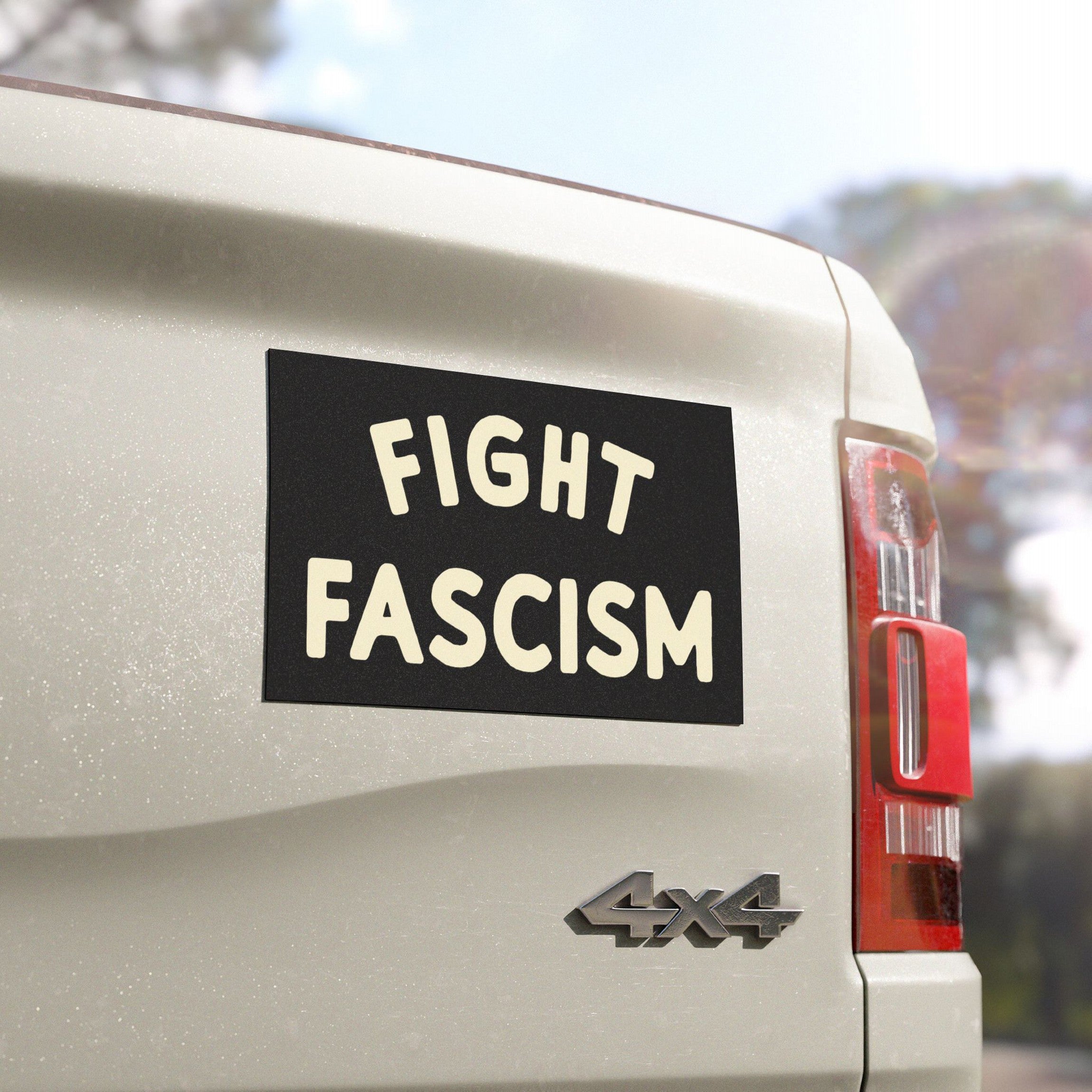 The tailgate of a 4x4 vehicle displays a Fight Fascism sticker in bold cream letters on black, embodying the Fight Fascism Sticker & Magnet's protest message against fascism and inequality.