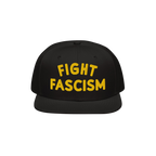 Black flat-brimmed hat with bold yellow FIGHT FASCISM embroidery on the front, promoting anti-fascist visibility. Ideal for p
