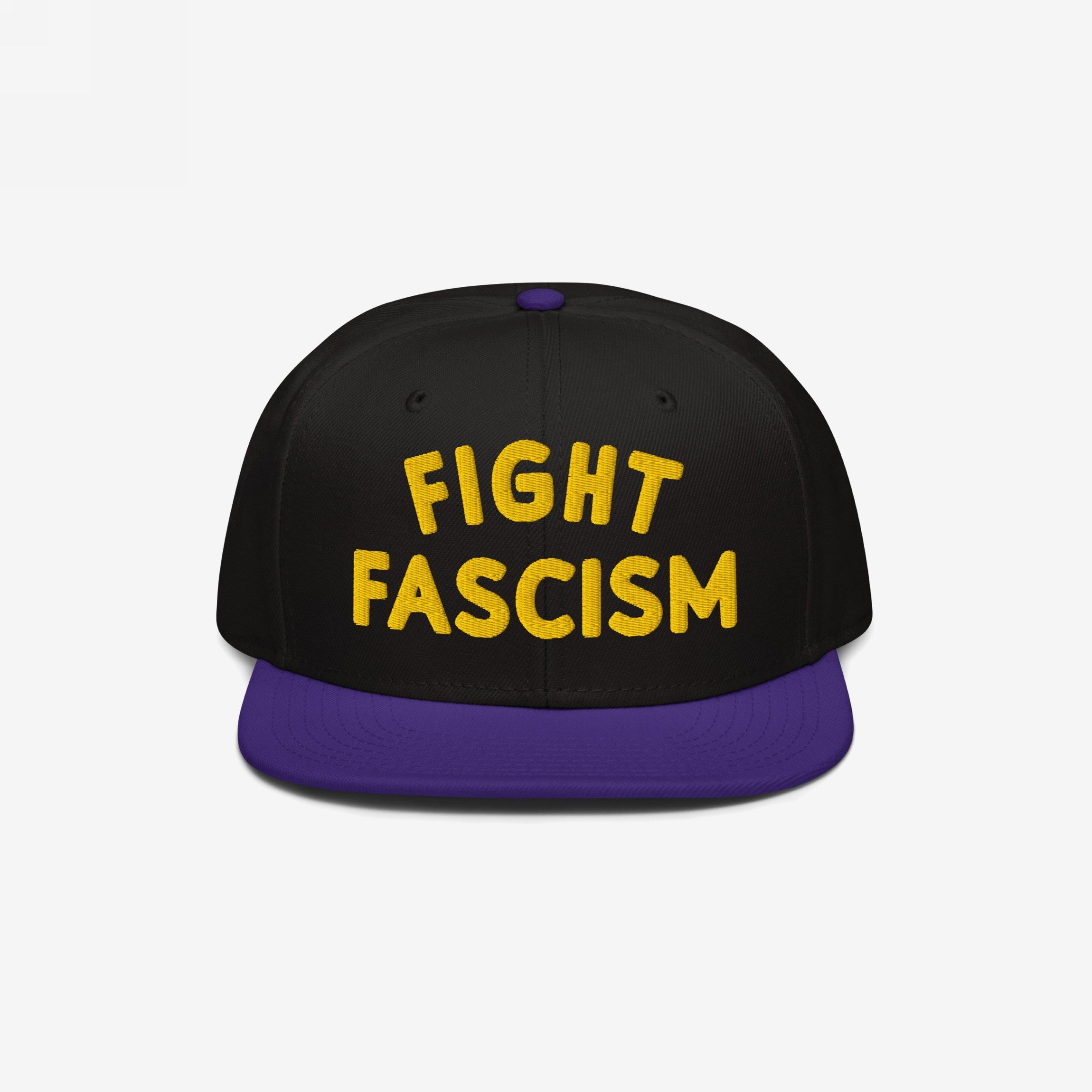 Fight Fascism Hat features bold yellow embroidery on a black crown, with a purple brim. Designed for visibility, this snapback cap makes a statement against fascism, supporting equality and inclusivity.