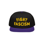 Fight Fascism Hat features bold yellow embroidery on a black crown, with a purple brim. Designed for visibility, this snapbac