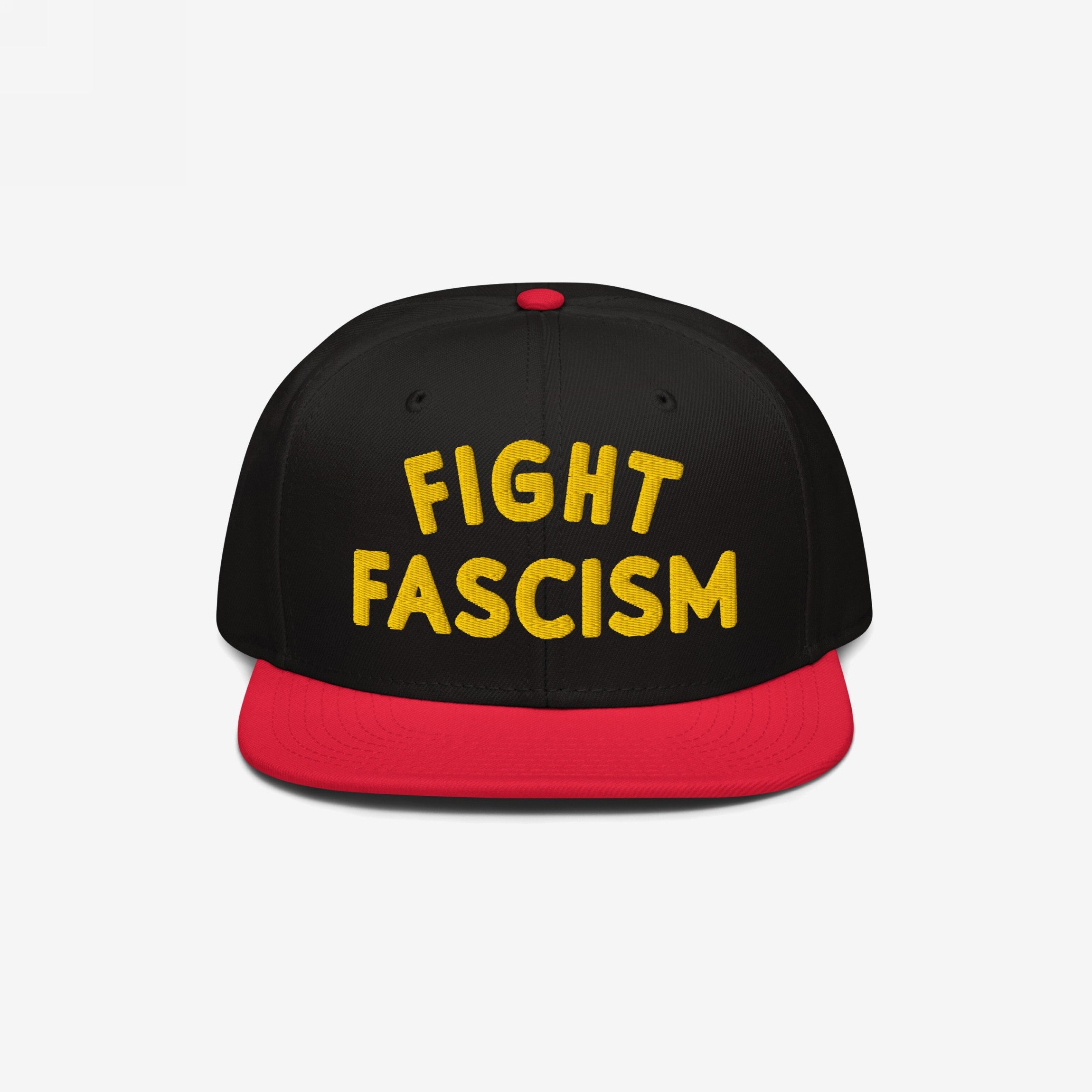 Black snapback hat with a red bill featuring bold yellow embroidery reading FIGHT FASCISM, embodying a protest spirit. Ideal for marches and daily wear to promote anti-fascist visibility.