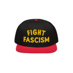 Black snapback hat with a red bill featuring bold yellow embroidery reading FIGHT FASCISM, embodying a protest spirit. Ideal 