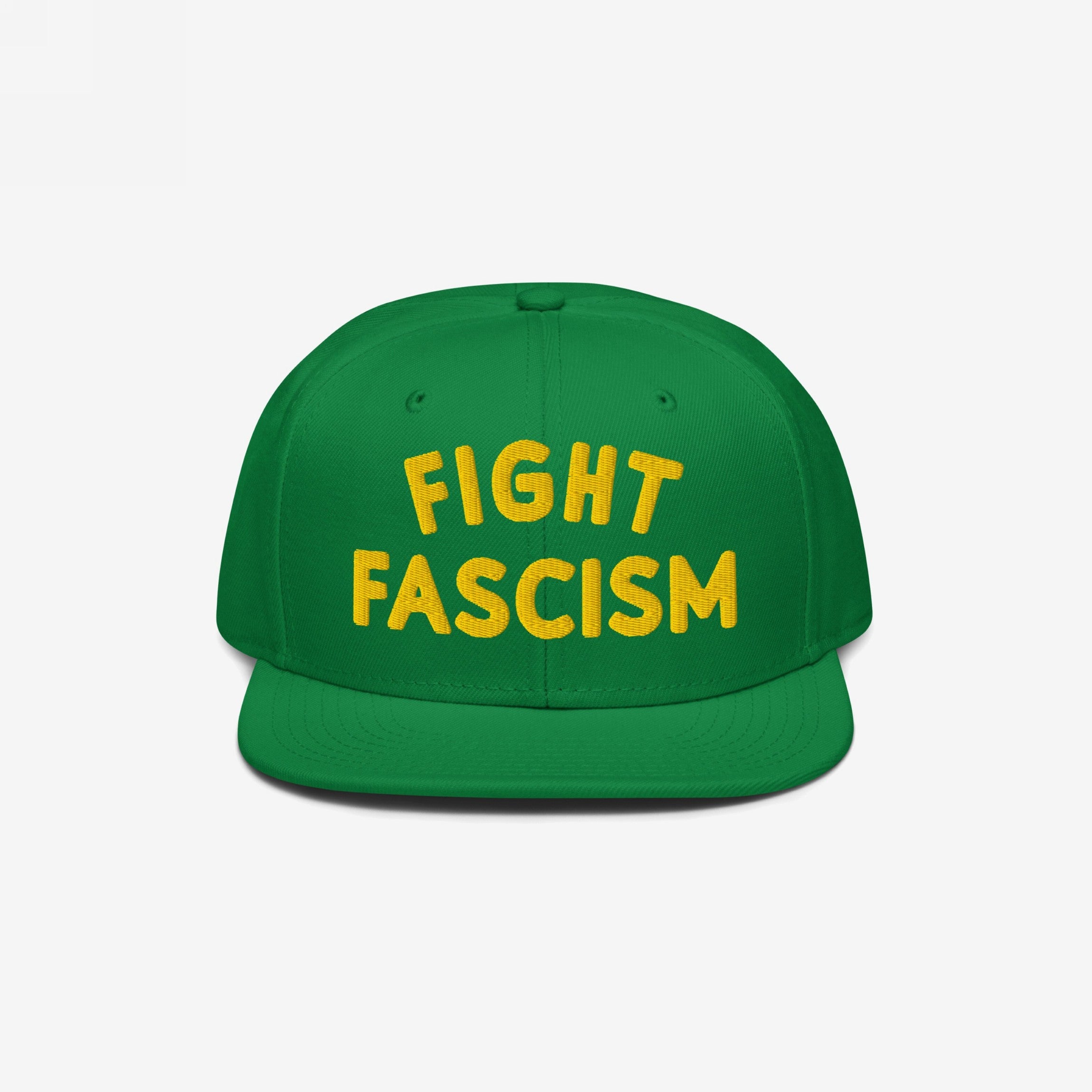 Green Fight Fascism Hat with yellow embroidered FIGHT FASCISM text on the front, featuring a flat brim. An anti-fascist statement piece for activism and daily wear, available in various styles.