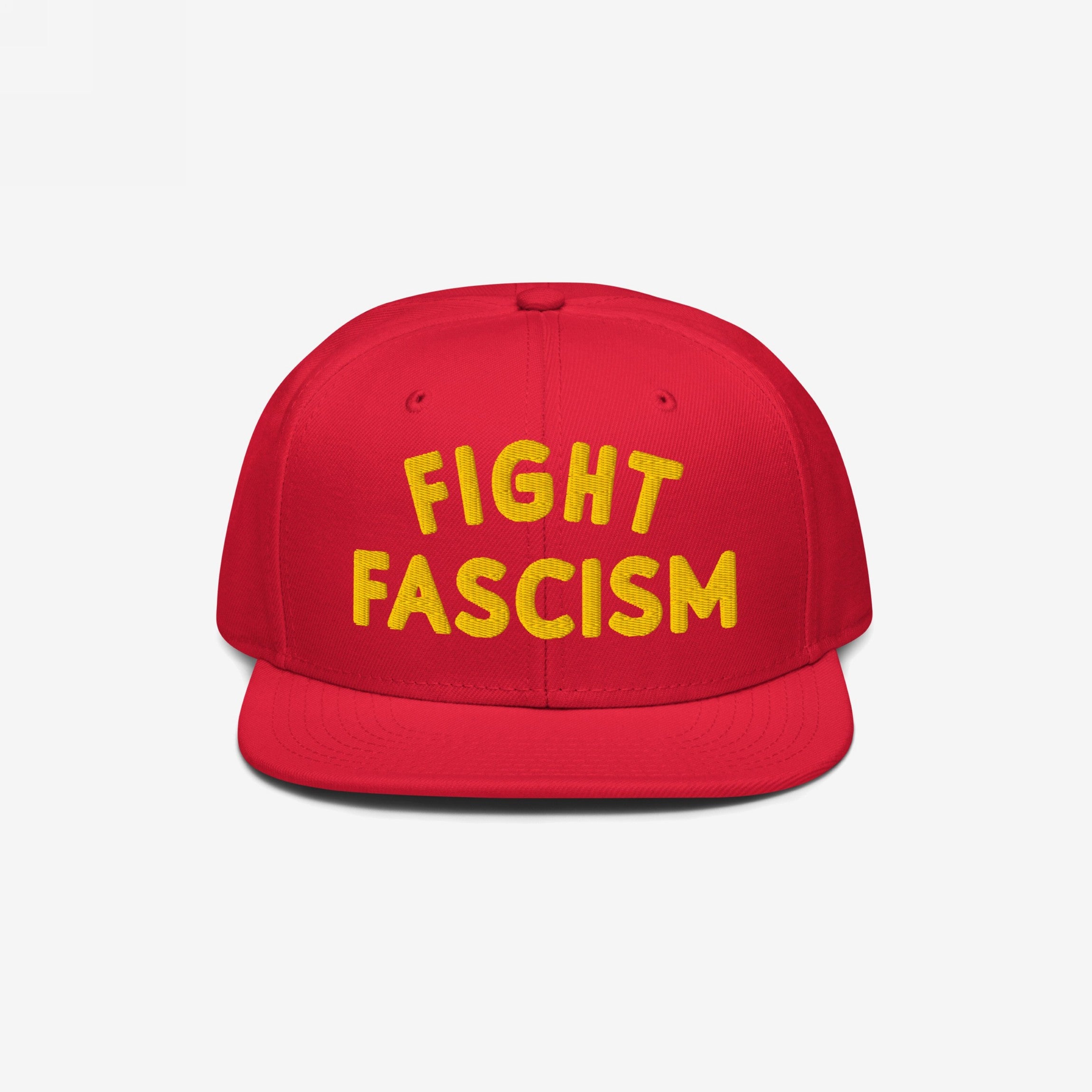 Fight Fascism Hat featuring a red snapback design with FIGHT FASCISM boldly embroidered in yellow. This statement piece supports anti-fascist causes, perfect for visible protest and daily wear.