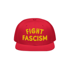 Fight Fascism Hat featuring a red snapback design with FIGHT FASCISM boldly embroidered in yellow. This statement piece suppo