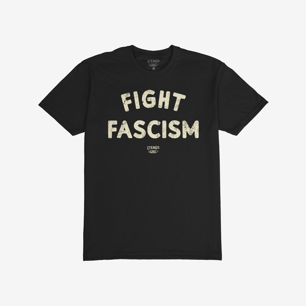 Black T-shirt with bold, off-white “FIGHT FASCISM” lettering across the chest, embodying an anti-fascist message. Below, smaller text subtly identifies the designer, enhancing the shirt's statement against hate.