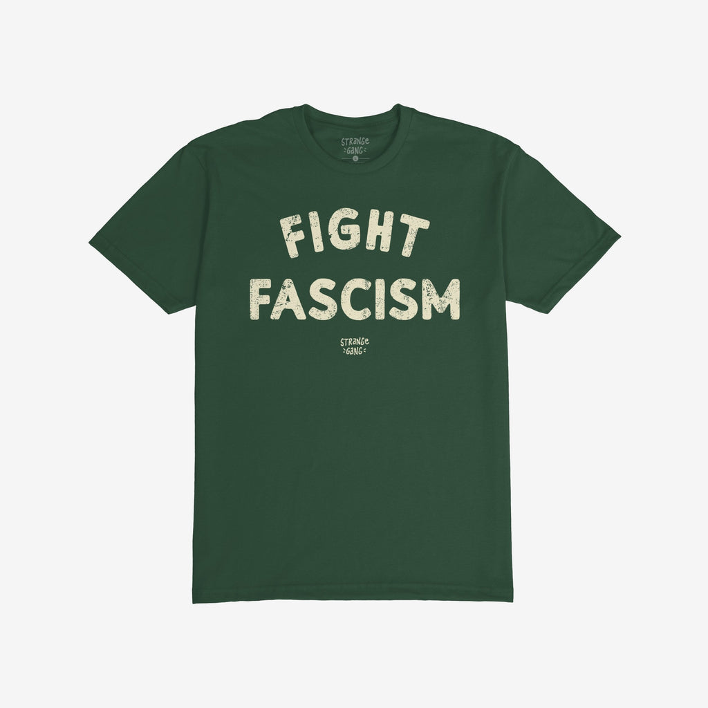 Dark green Fight Fascism T-shirt with large off-white distressed block letters across the chest, symbolizing anti-fascist protest. The smaller brand name appears beneath the main slogan.
