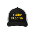 Trucker-style black-and-white Fight Fascism Hat with bold yellow embroidery. Ideal for protests or daily wear, aligning with 