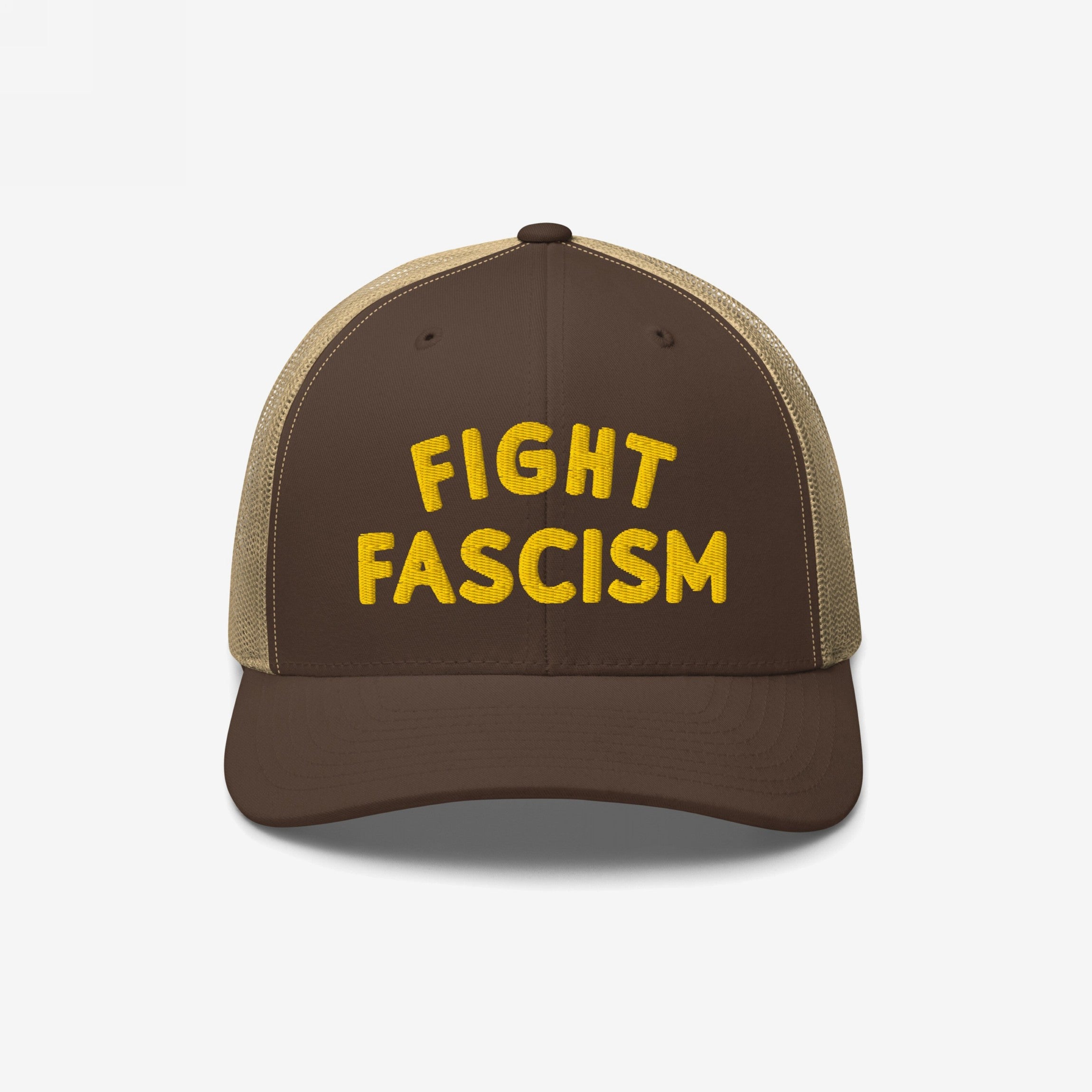 Fight Fascism Hat: Brown-and-tan mesh-back trucker style with bold yellow FIGHT FASCISM embroidery. Ideal for visible protest against hate, embodying anti-fascist message and standing for equality.
