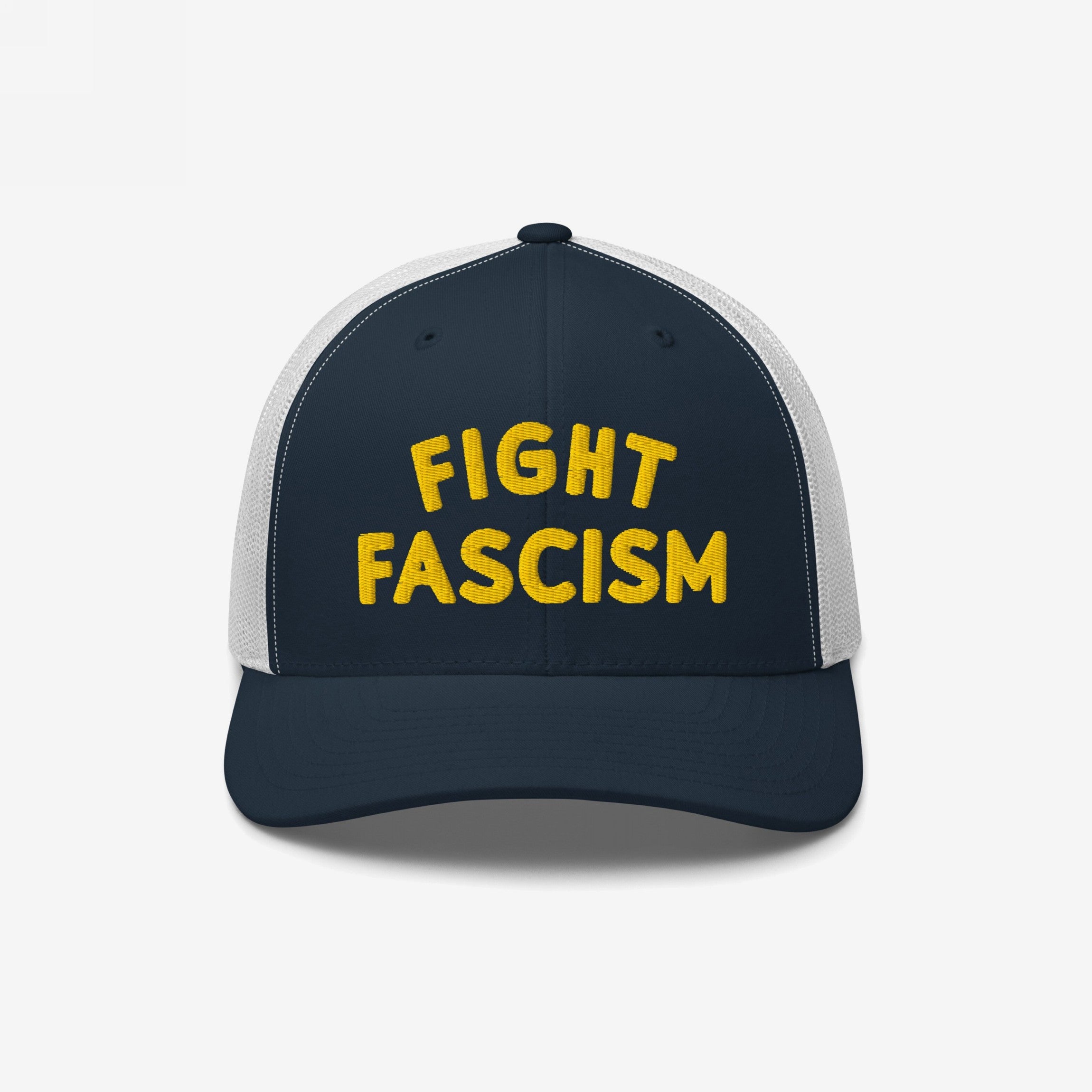 Navy-blue and white mesh trucker cap with yellow FIGHT FASCISM embroidery, embodying anti-fascist protest spirit. Ideal for visibility during marches or daily wear.