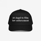 Film The Police Hat features a black baseball cap with white embroidered text stating, “it’s legal to film law enforcement,” emphasizing police accountability and rights awareness.