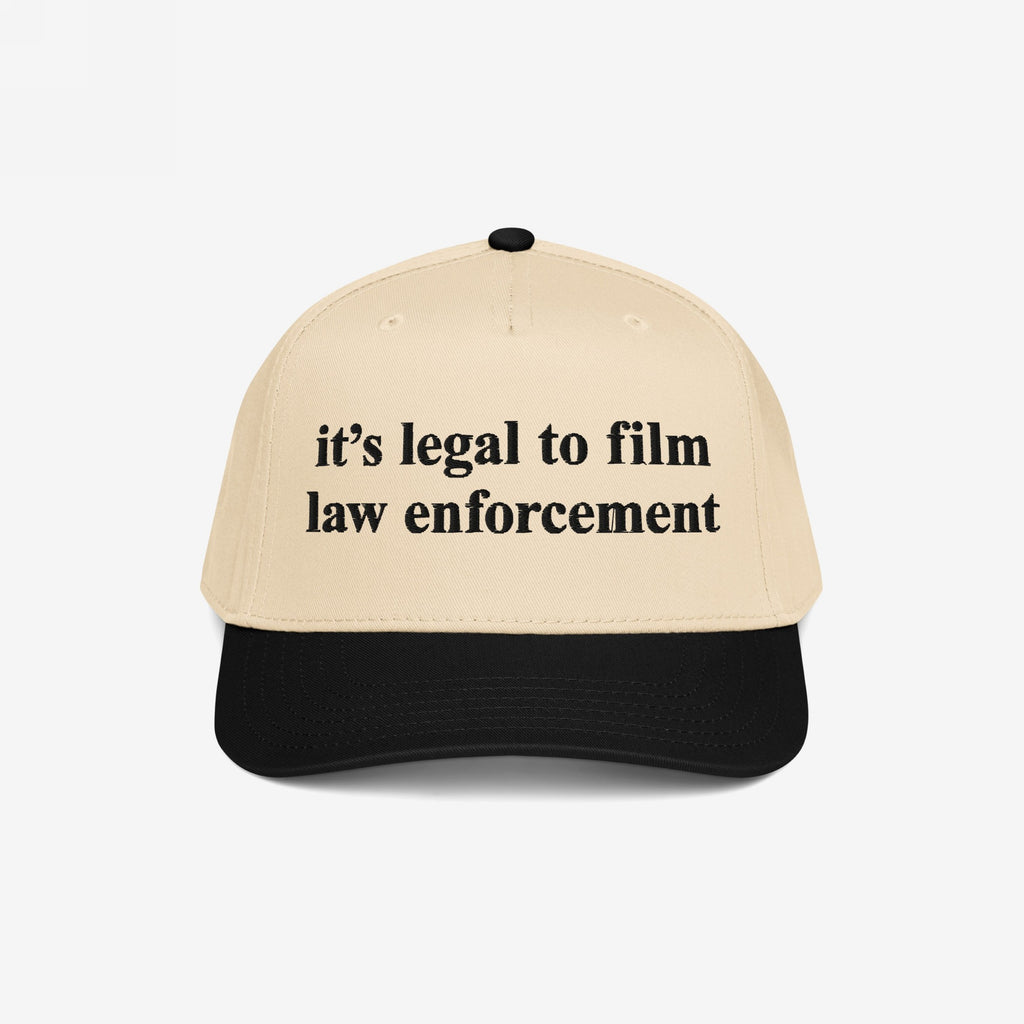 Film The Police Hat featuring a light tan front and black bill, boldly stating “it’s legal to film law enforcement.” A statement piece reflecting the fight for police accountability and rights awareness.