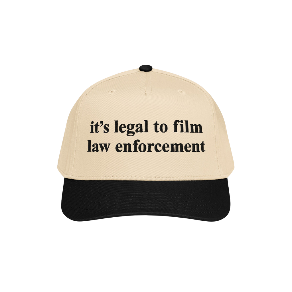 Film The Police Hat featuring a light tan front and black bill, boldly stating “it’s legal to film law enforcement.” A 