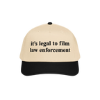 Film The Police Hat featuring a light tan front and black bill, boldly stating “it’s legal to film law enforcement.” A 