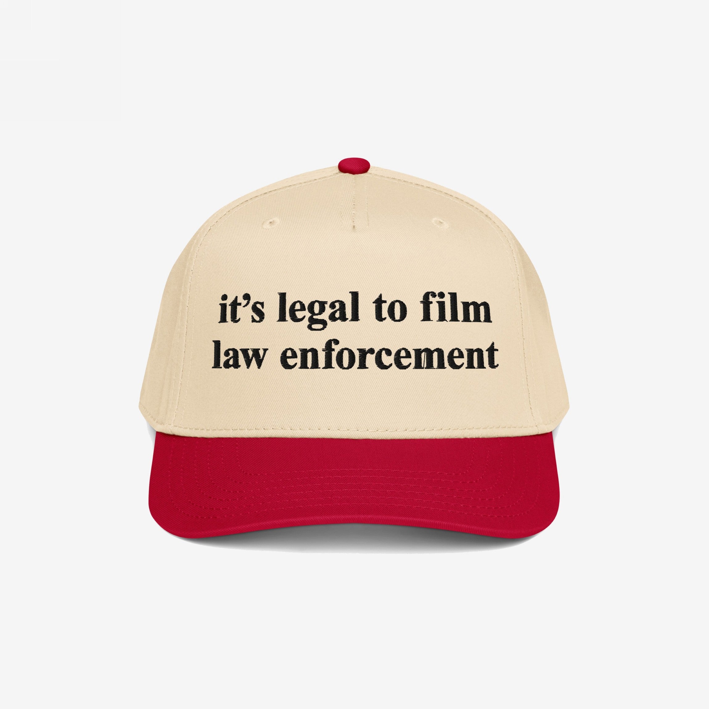 Film The Police Hat features a cream crown with a red bill, boldly embroidered with it’s legal to film law enforcement, offering a stylish reminder of rights and accountability.
