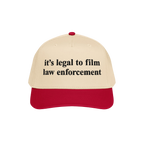 Film The Police Hat features a cream crown with a red bill, boldly embroidered with it’s legal to film law enforcement, off