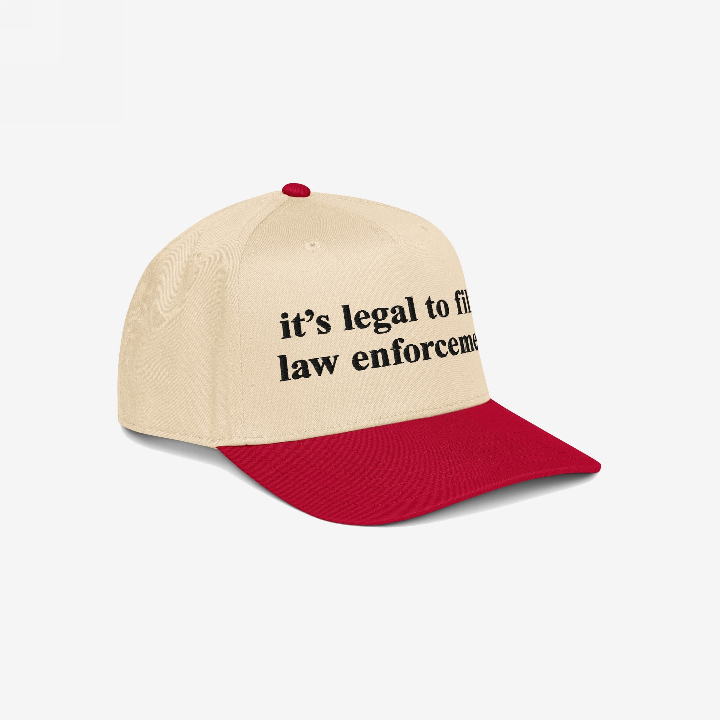Two-tone Film The Police Hat with a cream crown and red brim, featuring bold text it’s legal to film law enforcement. Perfect for those advocating police accountability and knowing your rights.