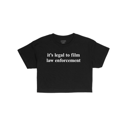 The Film The Police Women's Baby Tee features bold white text advocating for legal rights on a black T-shirt, embodying activ