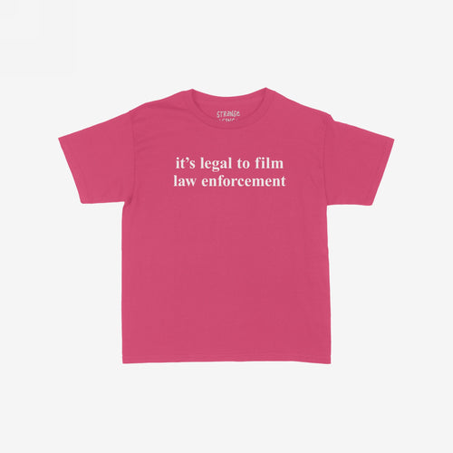 The Film The Police Women's Baby Tee showcases a bold message on a bright pink/magenta crew-neck, promoting police accountability with its statement, it’s legal to film law enforcement, in white text.