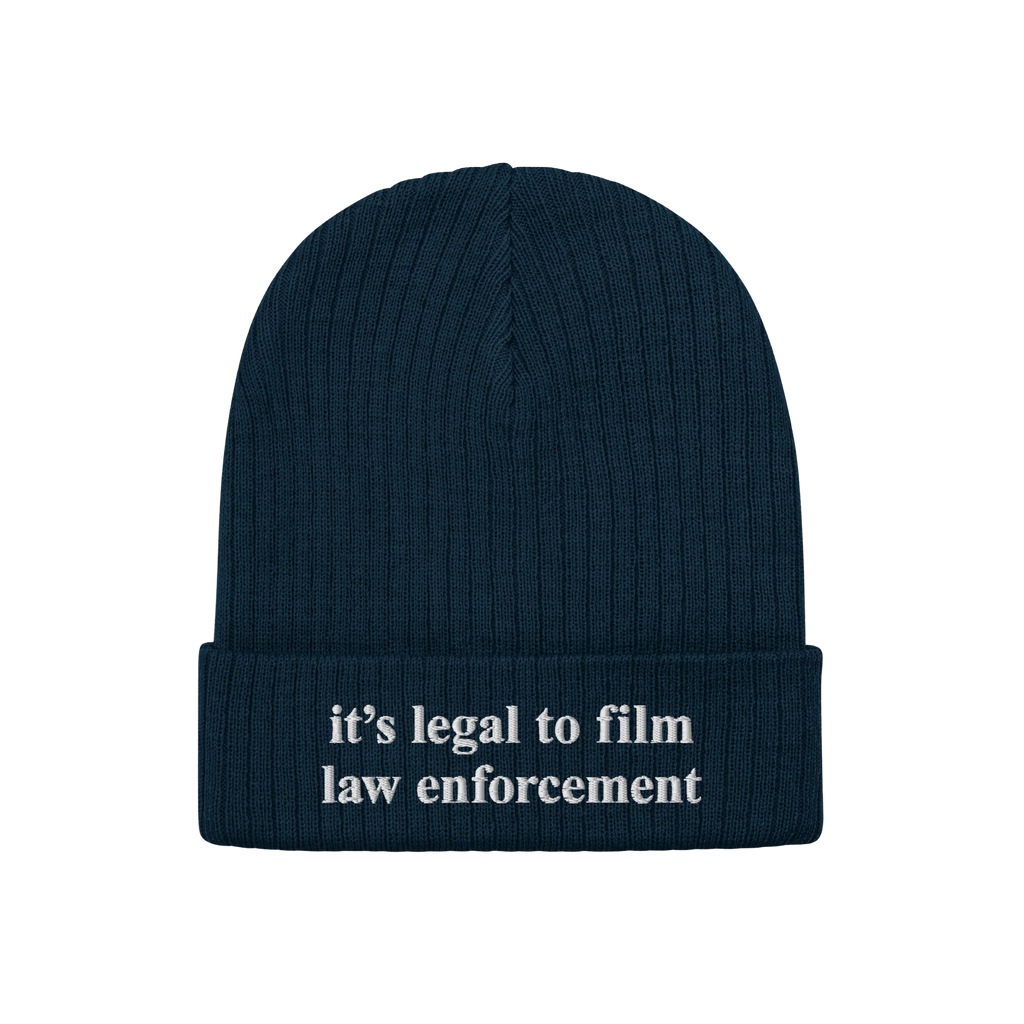 Film The Police Hat: A dark navy-blue ribbed knit beanie featuring white embroidered text it’s legal to film law enforcemen