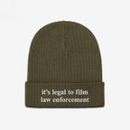 Olive-green ribbed knit beanie, Film The Police Hat, with it’s legal to film law enforcement embroidered in white on the cuff, reflecting a stand for police accountability.