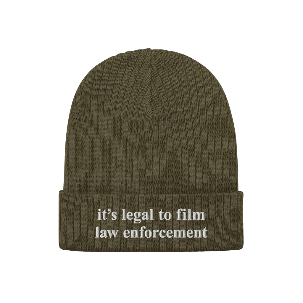 Olive-green ribbed knit beanie, Film The Police Hat, with it’s legal to film law enforcement embroidered in white on the cu