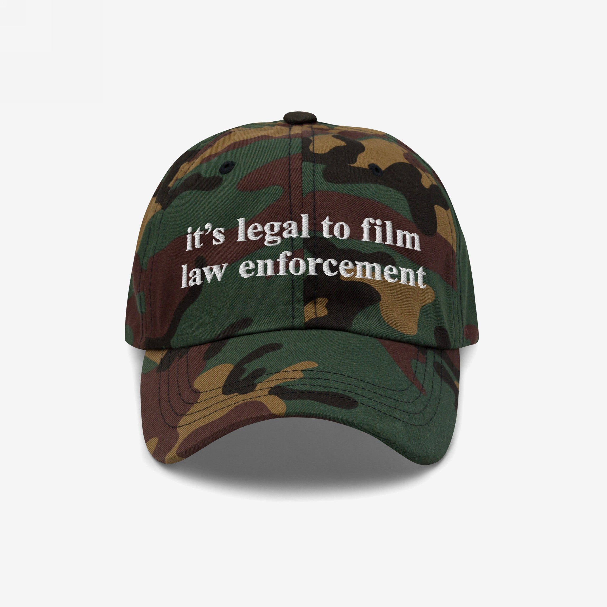 Camouflage-pattern baseball cap with white it’s legal to film law enforcement embroidery. The Film The Police Hat emphasizes rights awareness and police accountability, reflecting a commitment to social justice.