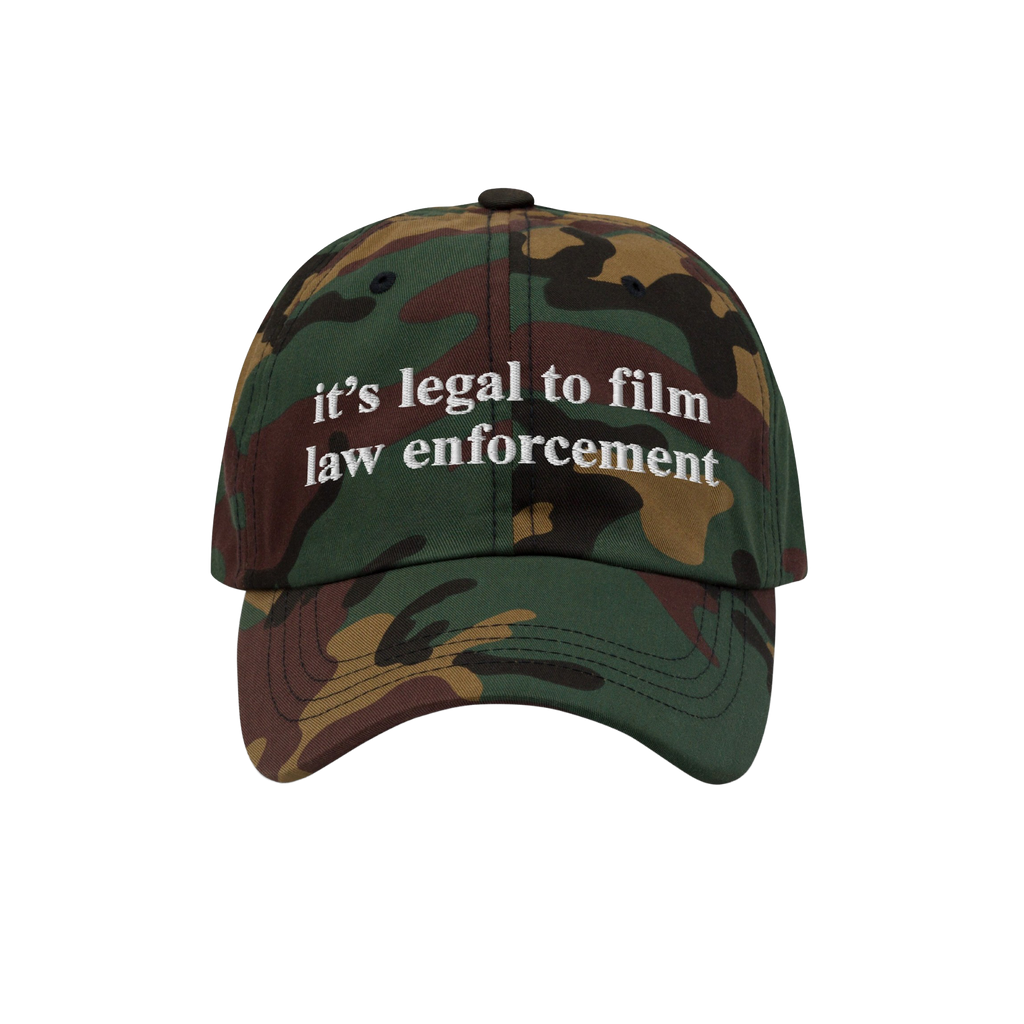 Camouflage-pattern baseball cap with white it’s legal to film law enforcement embroidery. The Film The Police Hat emphasize