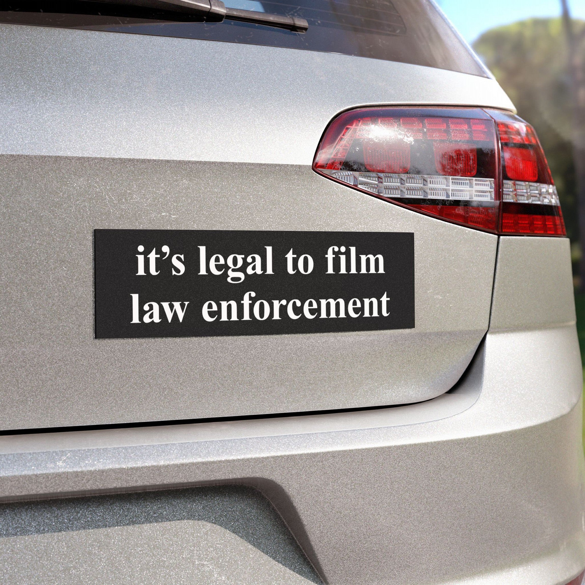 Film The Police Sticker & Magnet displayed on a silver car’s rear, emphasizing the message It’s legal to film law enforcement in bold, high-contrast font, reflecting police accountability and rights awareness.